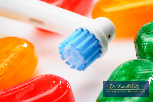 Halloween candy with toothbrush and floss for fall dental tips in Orange, CA